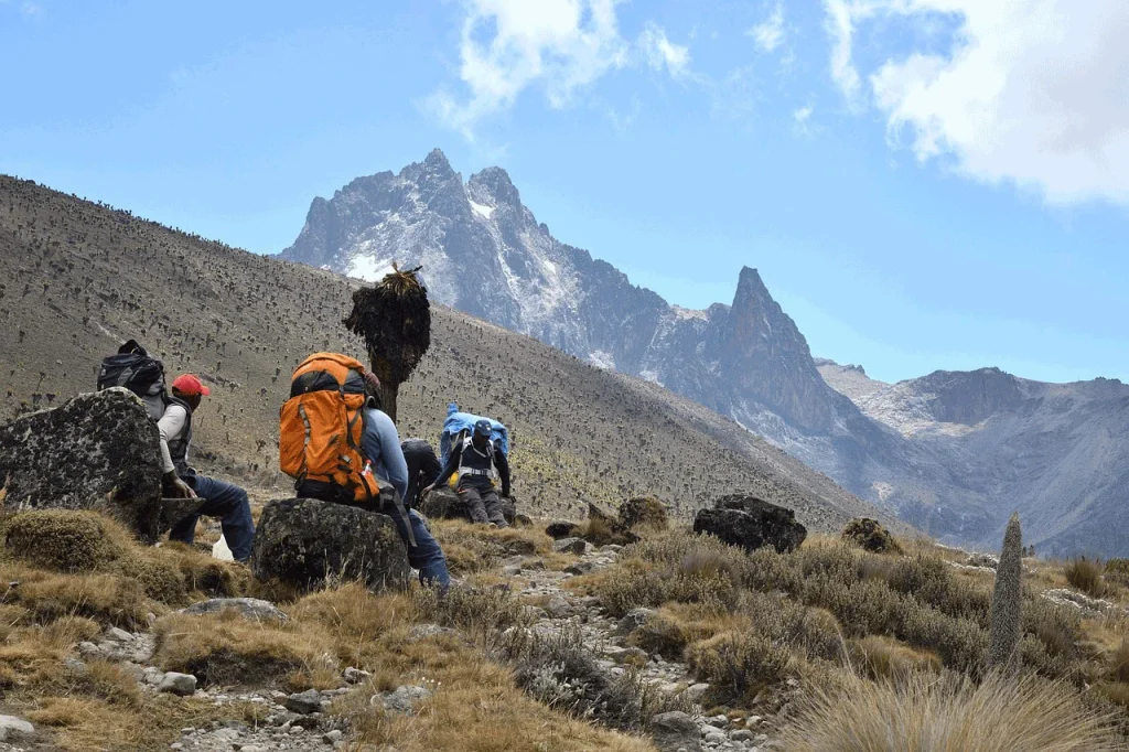 Mount Kenya climbing packages – hikers ascending Point Lenana at sunrise